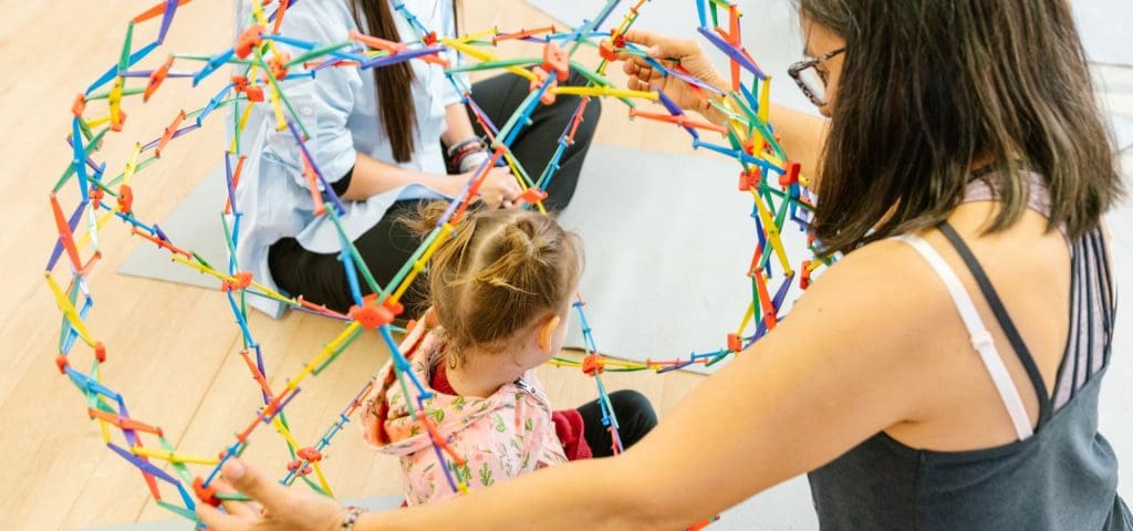 Educator at Wonder Garden Learning Center guiding a small group of children during a learning activity