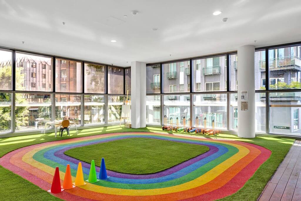 Artificial grass in rainbow colors used as flooring in a room