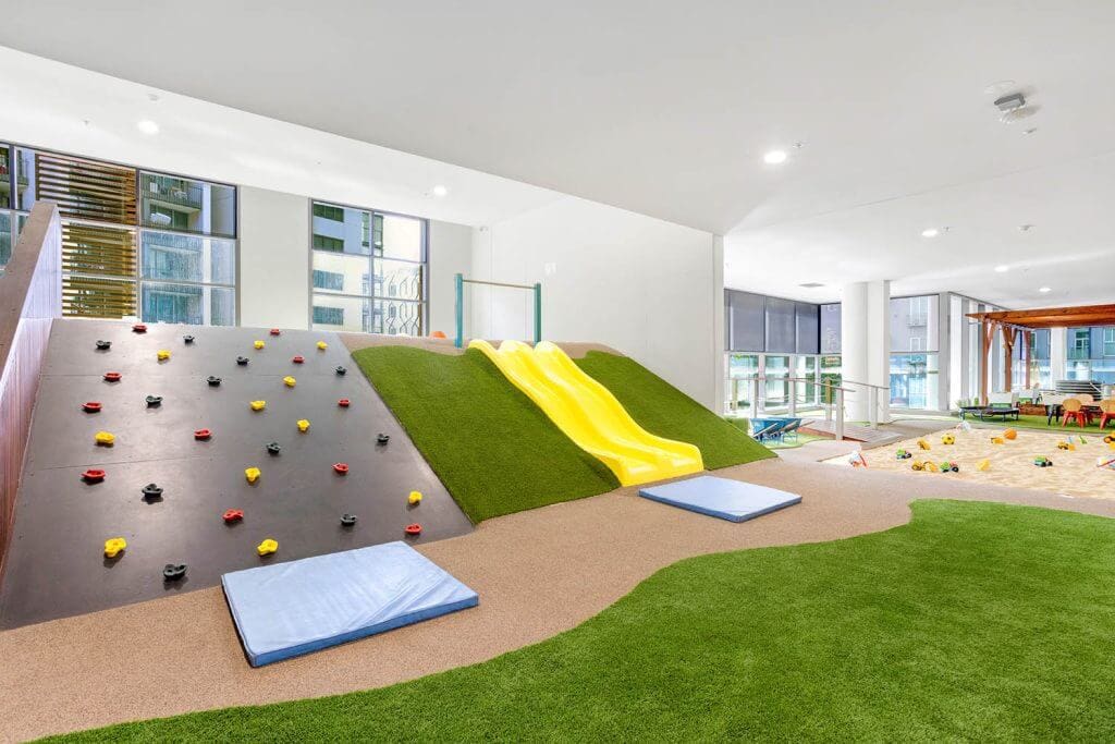 Indoor playground at Wonder Garden Learning Center featuring a colorful slide and soft play equipment, designed for safe and active play