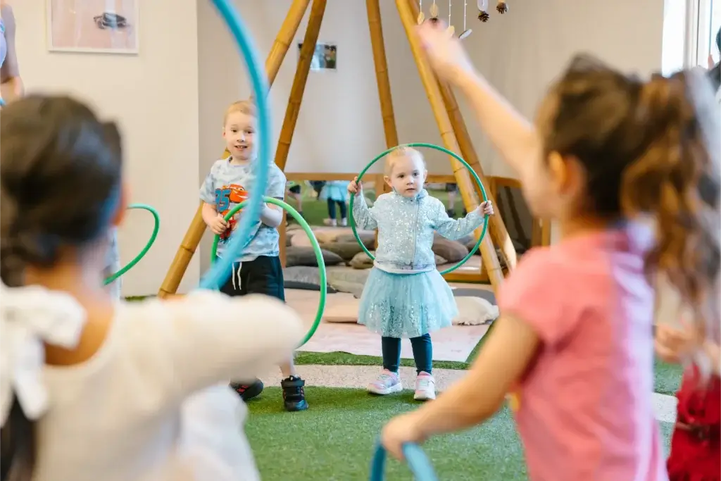 Educator at Wonder Garden Learning Center guiding a small group of children during a learning activity