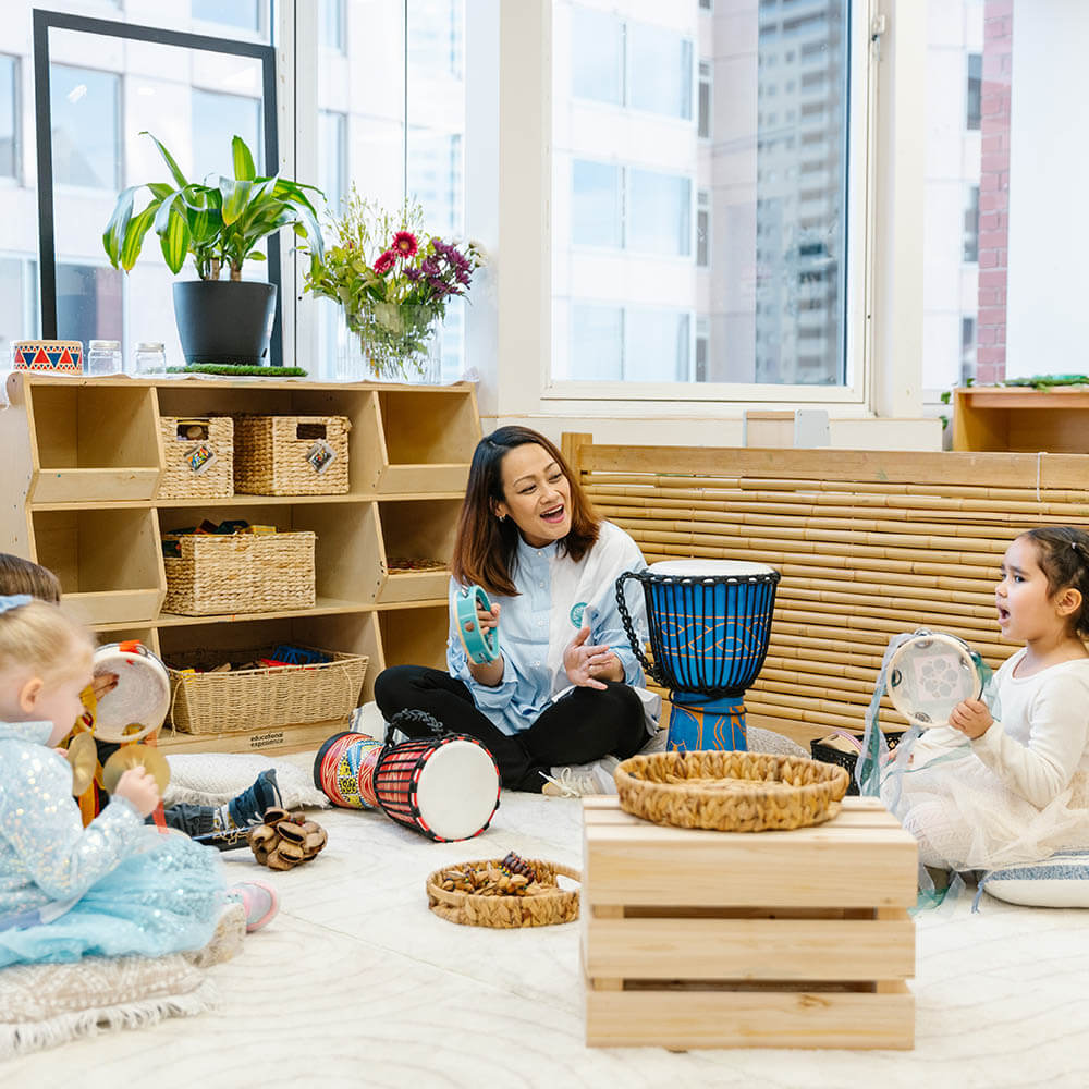 Educator at Wonder Garden Learning Center guiding a small group of children during a learning activity