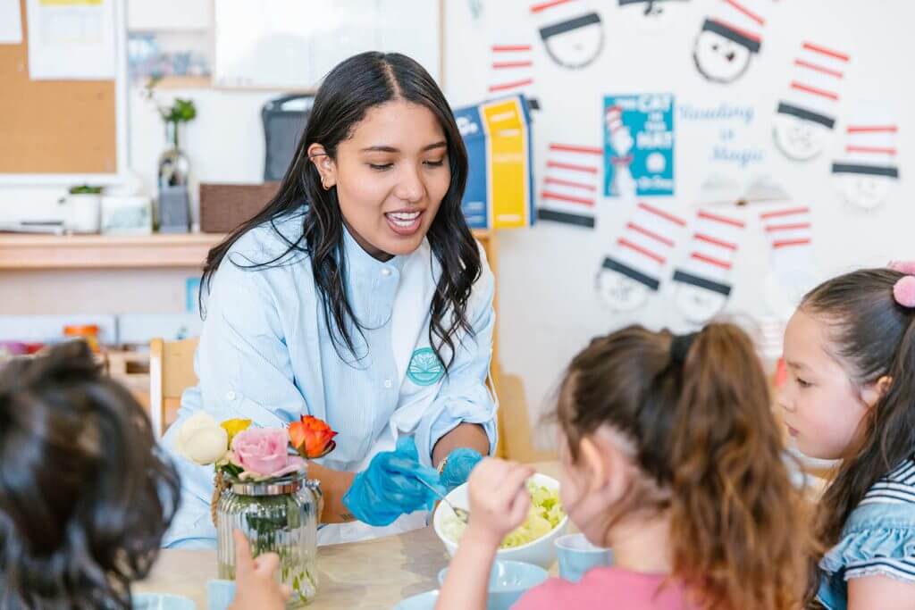Educator at Wonder Garden Learning Center guiding a small group of children during a learning activity