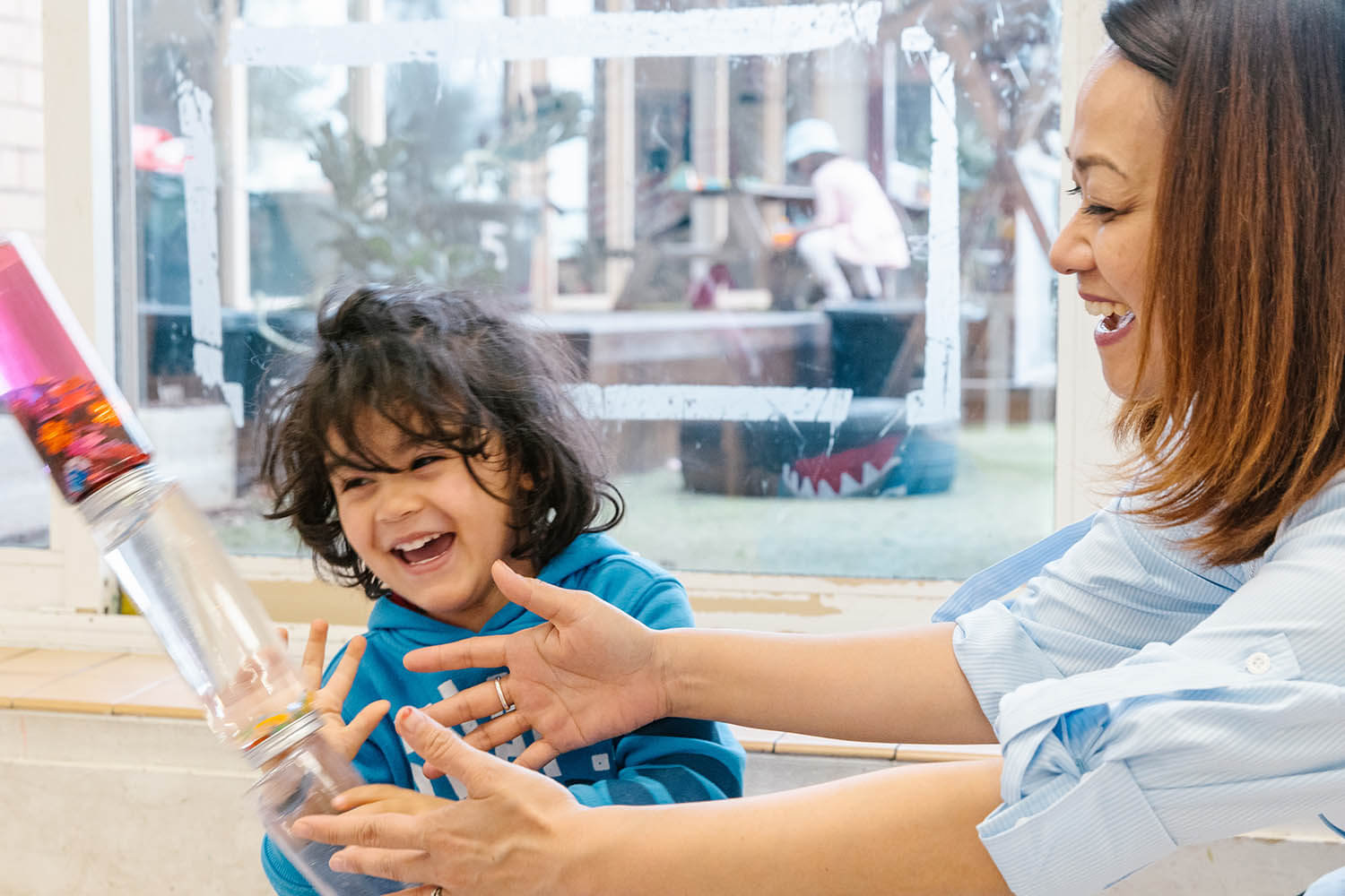 Educator at Wonder Garden Learning Center guiding a small group of children during a learning activity